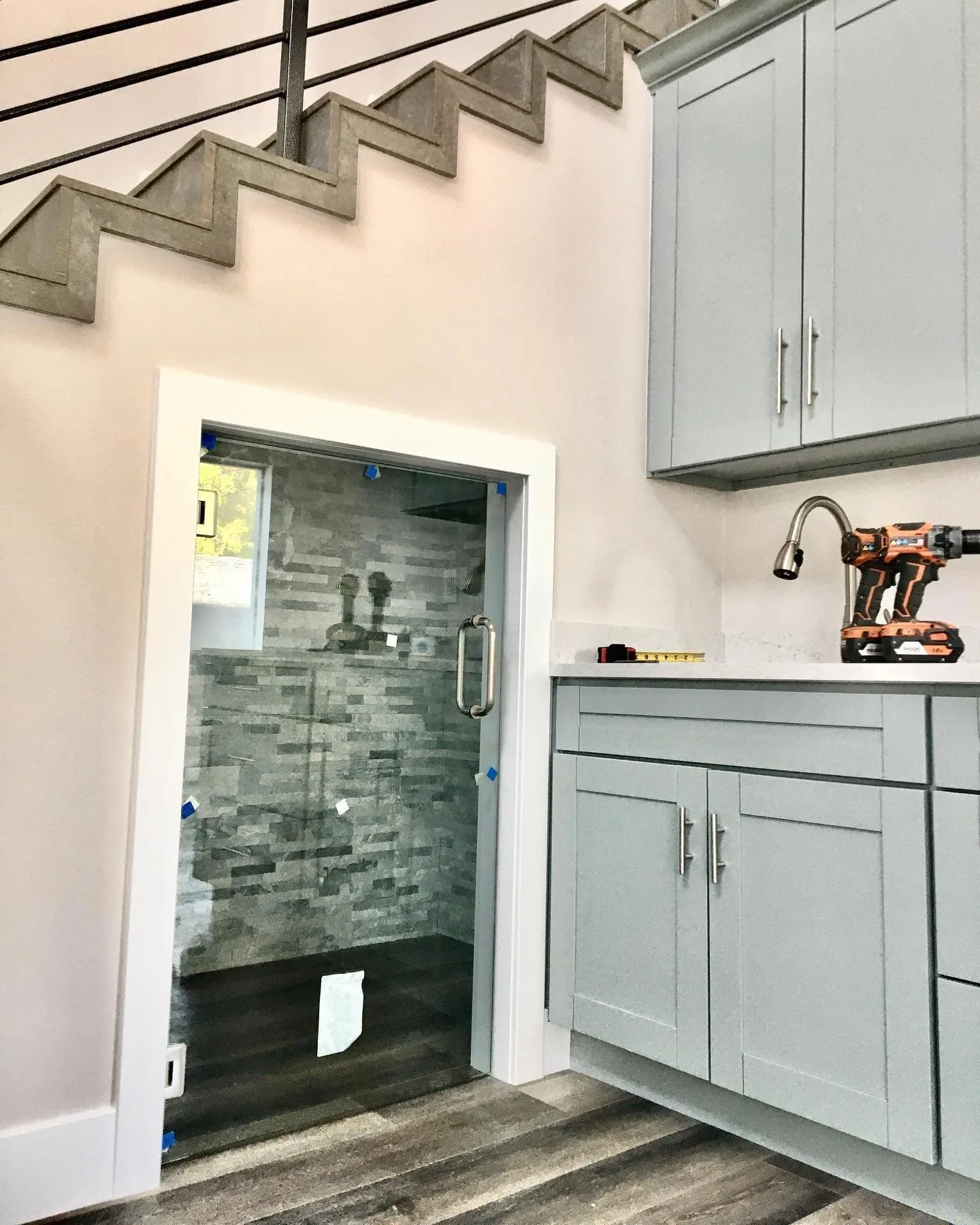 Under-stair custom shower installation with frameless glass door