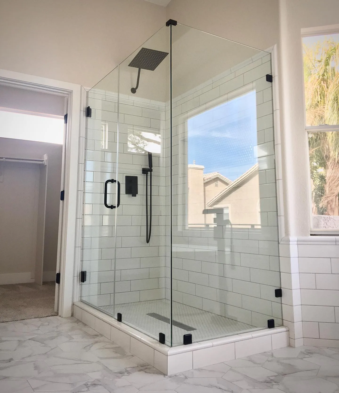 Corner shower with subway tile and black fixtures