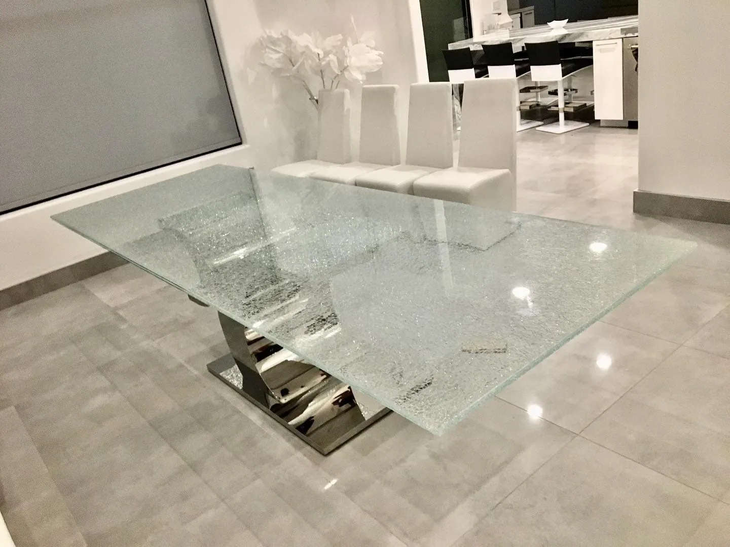 Custom glass dining table with modern base