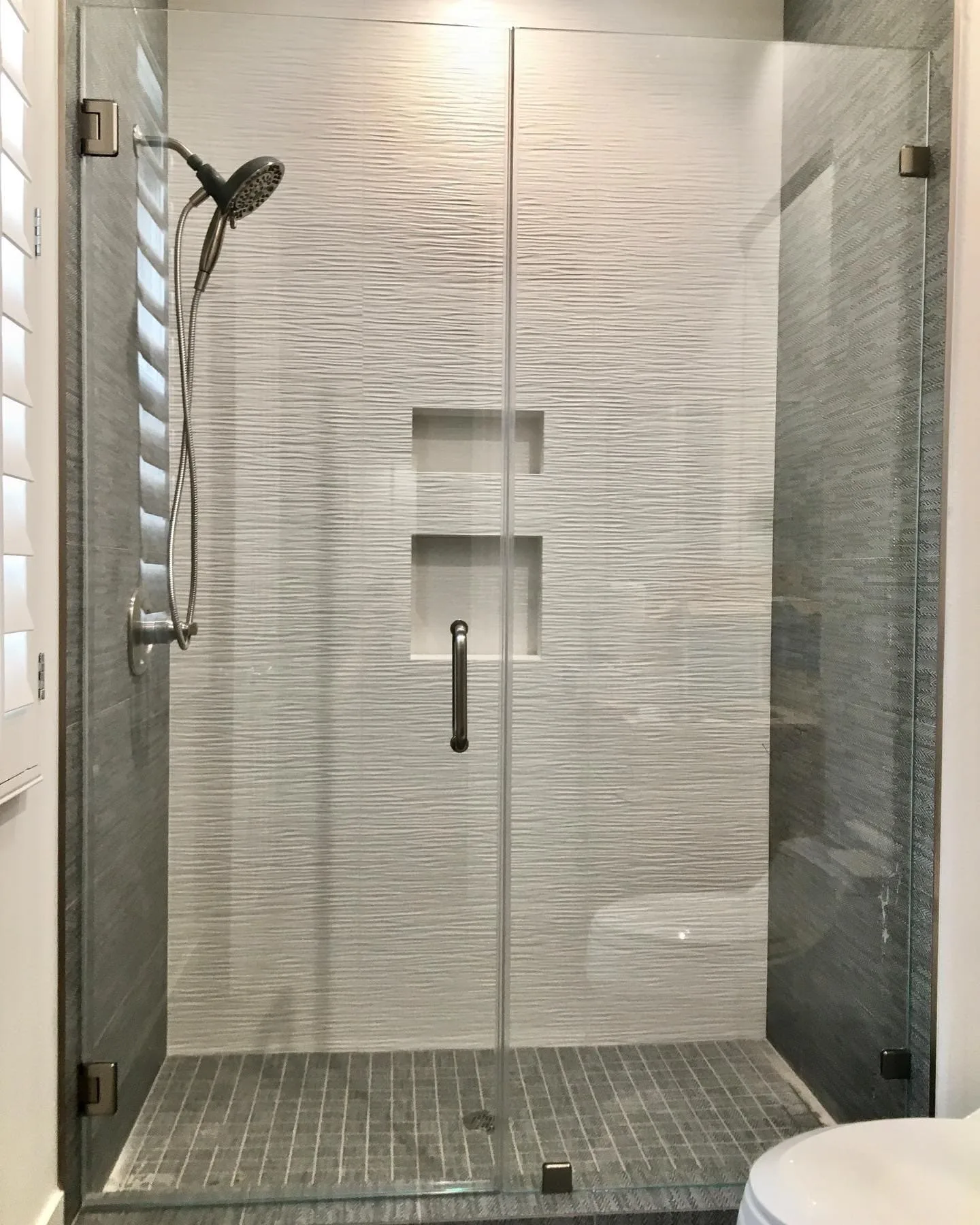 Textured glass shower doors with black hardware