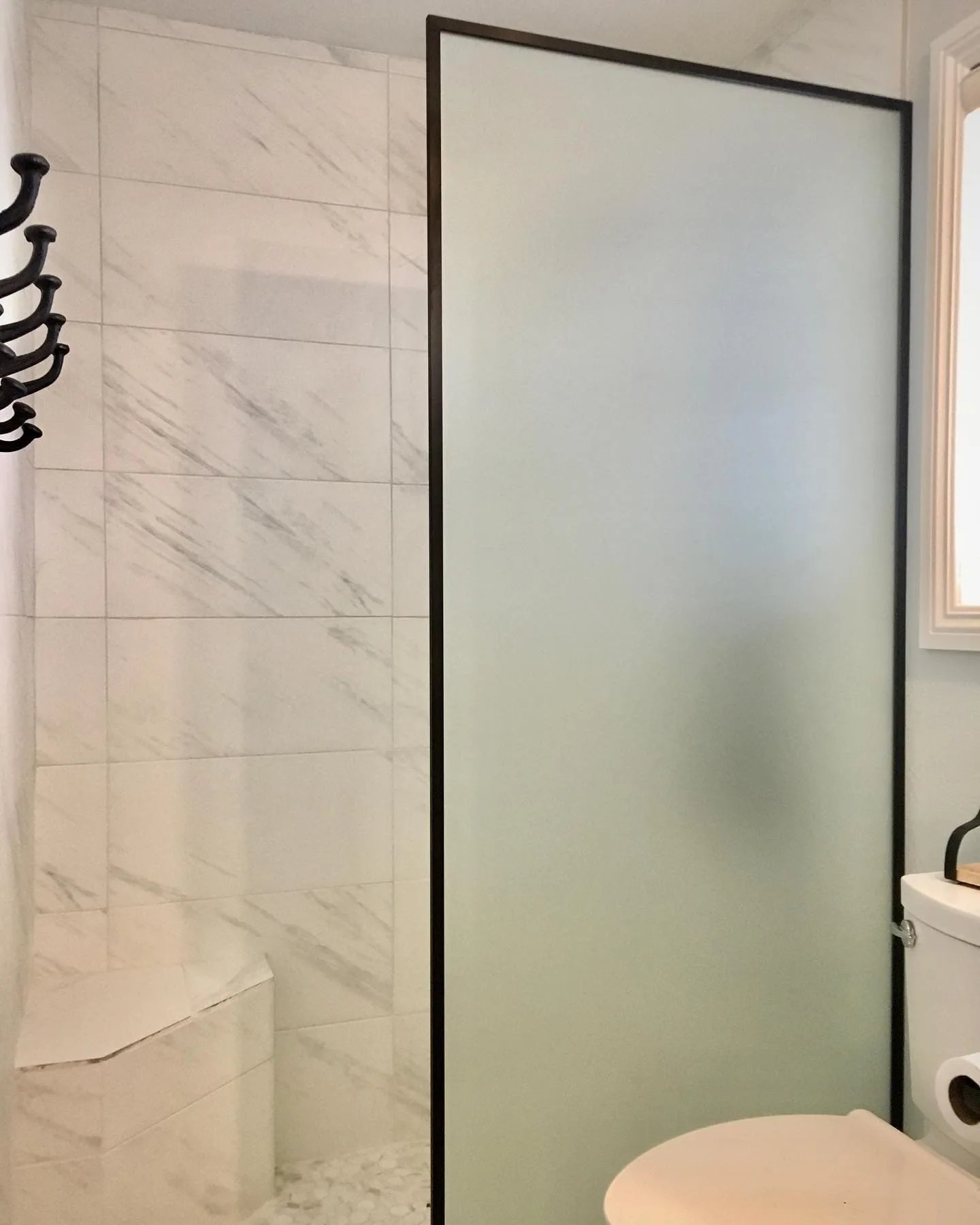 Frosted glass shower panel with black frame