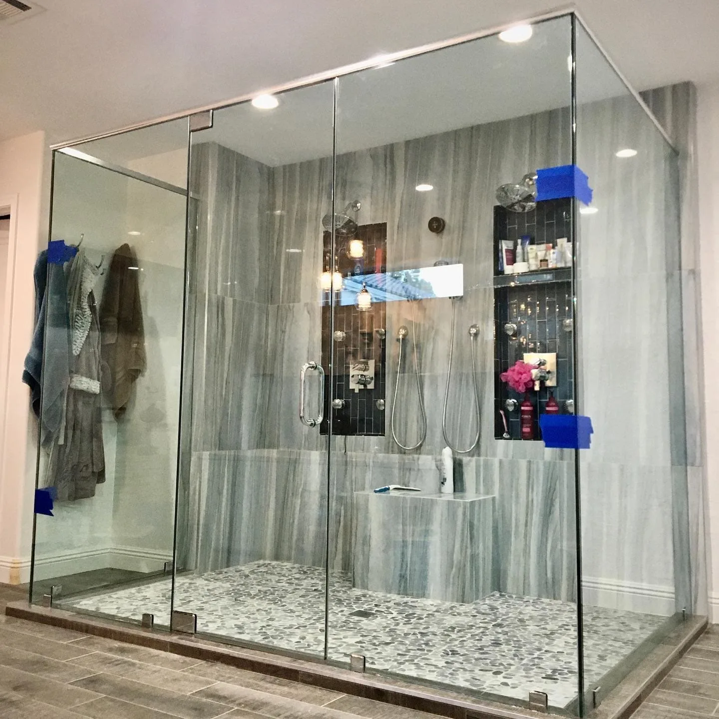 Large custom shower enclosure with glass niches and built-in seating