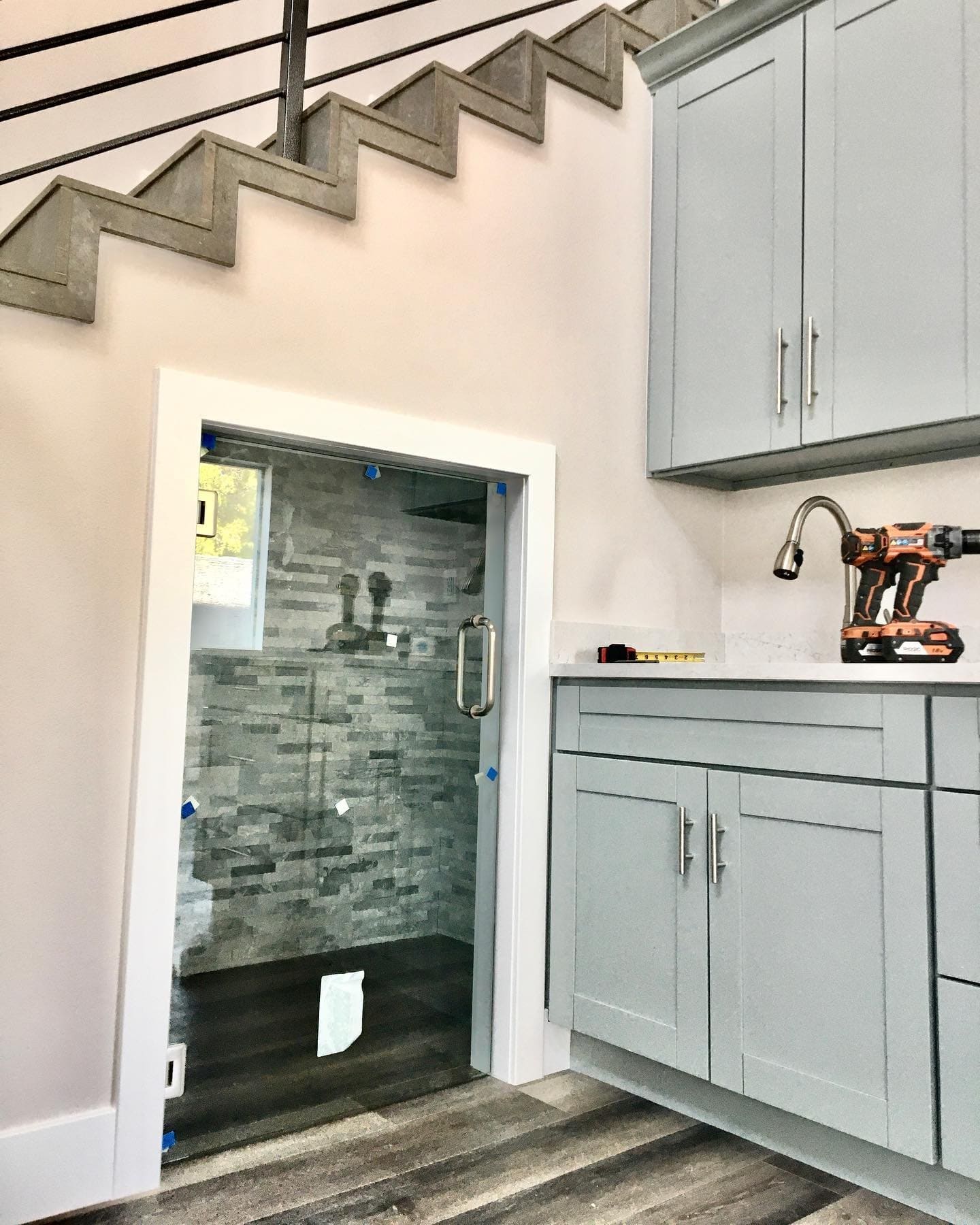 Under-stair shower installation with custom glass door