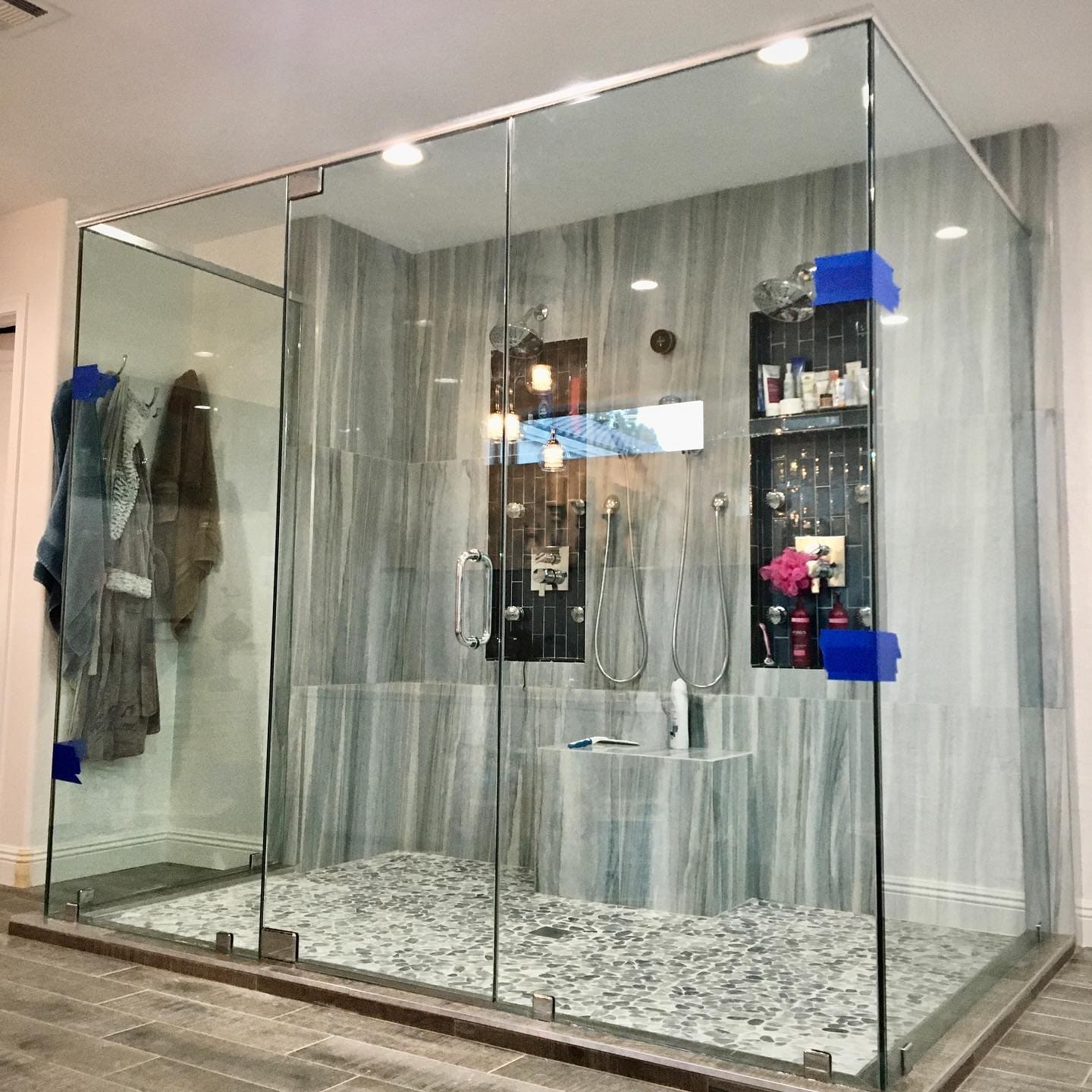 Large custom shower enclosure with glass niches and built-in seating